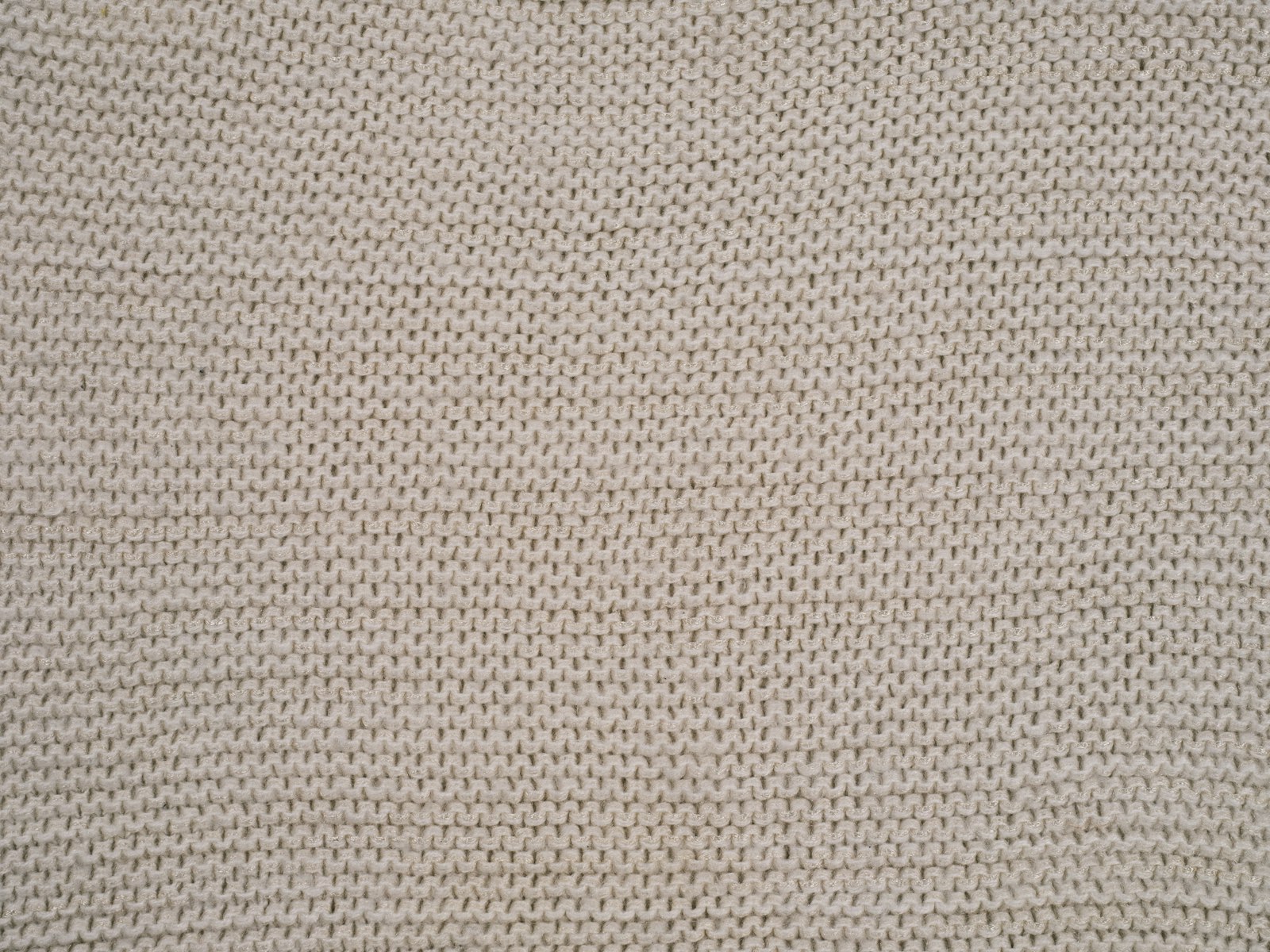 Close-up of an ivory knitted upholstery fabric texture