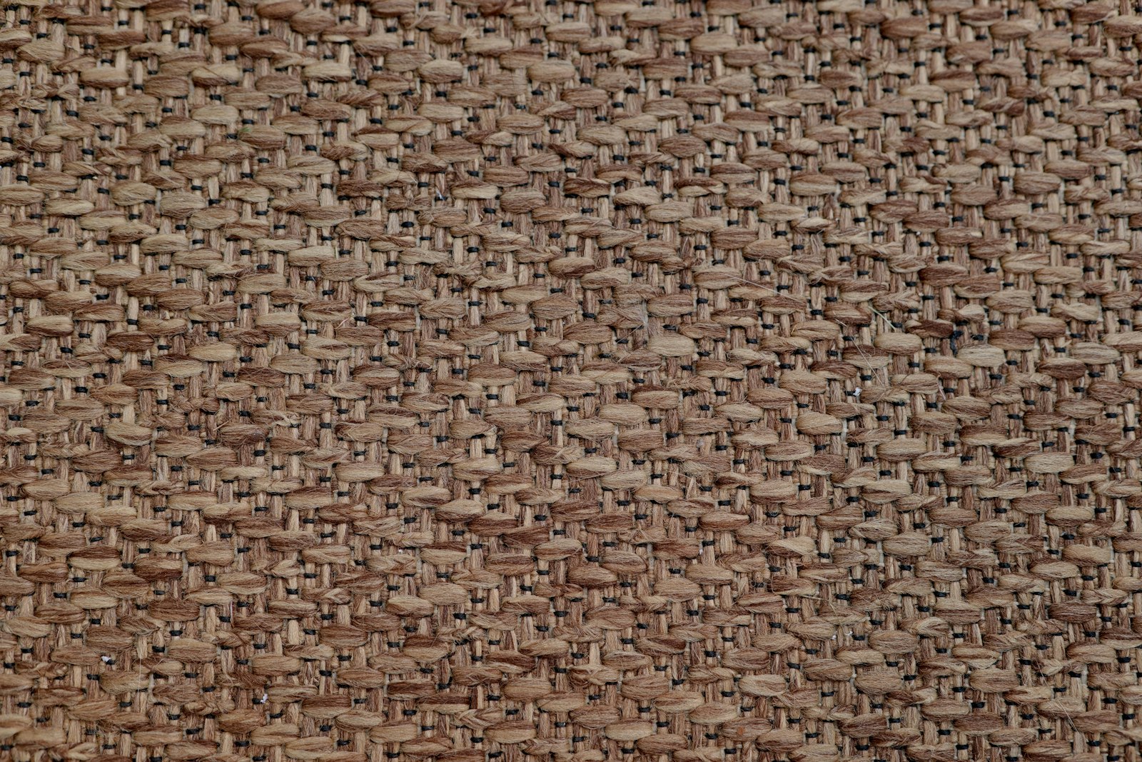 Close-up of a rust-toned woven upholstery fabric